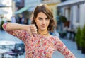 Upset young woman showing thumbs down sign, disapproval, dissatisfied bad work, mistake in city Royalty Free Stock Photo