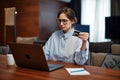 Upset young woman worker using online banking on laptop, trouble blocked credit card. Internet fraud, bankruptcy, debt Royalty Free Stock Photo