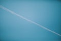 Upshot of beautiful blue clear sky with a perpendicular airplane trail