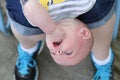 Upside down baby boy and mommy's feet closeup