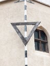 An upside down black triangle sign on pole seafront Royalty Free Stock Photo