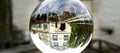 Upside down large building in a glass ball on a stone parapet, blurred background Royalty Free Stock Photo