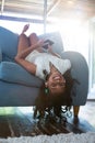 Upside down portrait of girl relaxing on armchair