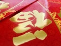 Upside-down red envelope bag with calligraphy characters of good luck.