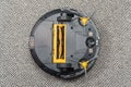 Upside down robot vacuum cleaner on carpet