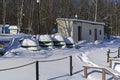 Upside-down snow-covered boats