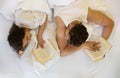Upside down top view of an romantic, attractive, contented, young, sexy couple, man and woman, sunday morning in white bed, Royalty Free Stock Photo