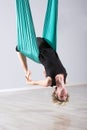 Upside down woman doing aerial yoga back bends