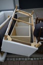 Upside down wooden frame of a white sofa or bed