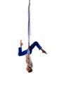 Upside down. Young male professional aerial gymnast, acrobat training on aerial fabric against white studio background