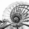 Upside view of indoor spiral winding staircase with black metal ornamental handrail Royalty Free Stock Photo