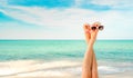 Upside woman feet and red pedicure wear pink sandals, sunglasses at seaside. Funny and happy fashion young woman relax on vacation Royalty Free Stock Photo