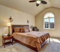 Upstairs bedroom with vaulted ceiling and arch window