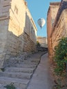 Upstairs to the light - stone stairs to the open air freedom and light with flying balloon Royalty Free Stock Photo