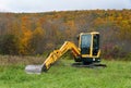 Upstate New York, U.S - October 17, 2022 - A yellow Hyundai tractor with the background of fall foliage Royalty Free Stock Photo