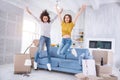 Cheerful young girls jumping happily in new apartment Royalty Free Stock Photo