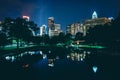 The Uptown skyline and a lake at Marshall Park at night, in Char