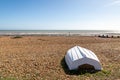 An upturned boat on the pebble beach, at Pett Level on the Sussex coast