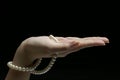Upturned hand with pearls Royalty Free Stock Photo