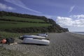 Upturned rowing boats on Branscombe Beach, Devon, on a sunny spring day. Royalty Free Stock Photo