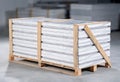 Upvc windows or doors wrapped up with stretch film, packed in a wooden euro pallet and waiting for shipping in a warehouse