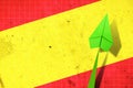 Upward arrow on the background of the flag of Spain. Paper plane. Economic recovery. Copy space. Business