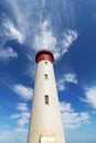 Red and White Lighthouse Extending Towards Blue Cloudy Sky