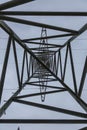 Upward looking image inside a power pole with structure of the steel frame