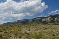 Mountainside view with thick cotton clouds in the skies along North Fork Highway in Wyoming Royalty Free Stock Photo