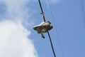 Shot of running shoes hanging from electric wires