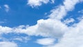 Upward skyscape view to cloudscape, shape of white fluffy clouds look like the eagle flying on vivid blue sky Royalty Free Stock Photo