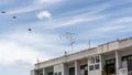 Upward view of old building under beautiful white fluffy cloud formation on vivid blue sky in a sunny day Royalty Free Stock Photo