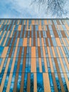 Upward view to modern corporate building with windows and bronze panels Royalty Free Stock Photo