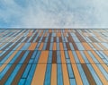 Upward view to modern corporate building with windows and bronze panels Royalty Free Stock Photo