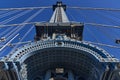 Upward view of a tower of the Manhattan Bridge with curved decorative steel work painted blue Royalty Free Stock Photo