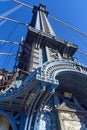 Upward view of a tower of the Manhattan Bridge with curved decorative steel work painted blue Royalty Free Stock Photo