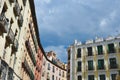 Upward view on vintage facades under dramatic grey sky downtown Madrid, Spain