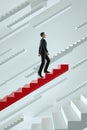 Upwards. Businessman climbs a red flying stairs.