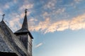 Upwards view of the bell tower of an old wooden church on a cloudy blue sunset sky in Maramures Royalty Free Stock Photo