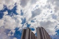 Upwards view of modern concrete apartment building against a beautiful blue sky with clouds Royalty Free Stock Photo