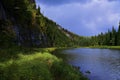 The Ural taiga river Usva flows near the steep gypsum rocks of the Usvinskie Stolby stone