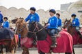 Nauryz holiday in Kazakhstan. Guys ride horses during the Nauryz holiday.