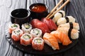 Uramaki and nigiri sushi served in black plate closeup. horizontal Royalty Free Stock Photo