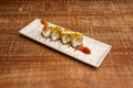 Uramaki sushi stuffed with gabardine prawns, Philadelphia cheese, banana
