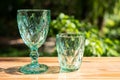 Uranium glass or Sapphire Crystal glass. Green tint color glassware vintage classic design old kitchenware on wooden table outdoor Royalty Free Stock Photo