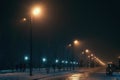 Urban alley in foggy winter night illuminated by street lamps Royalty Free Stock Photo