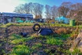 Urban allotment with wheelbarrow in the foregound