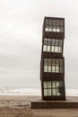 Urban art,sculpture L Estel ferit The Wounded Shooting Star, by Rebecca Horn in Barceloneta beach in a cloudy day. Barcelona.