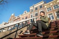 Urban asian man with backpack sitting on stairs. Good looking. C Royalty Free Stock Photo