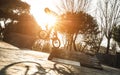 Urban athlete biker performing acrobatic jump at public park - Guy riding bmx bicycle at extreme sport competition Royalty Free Stock Photo